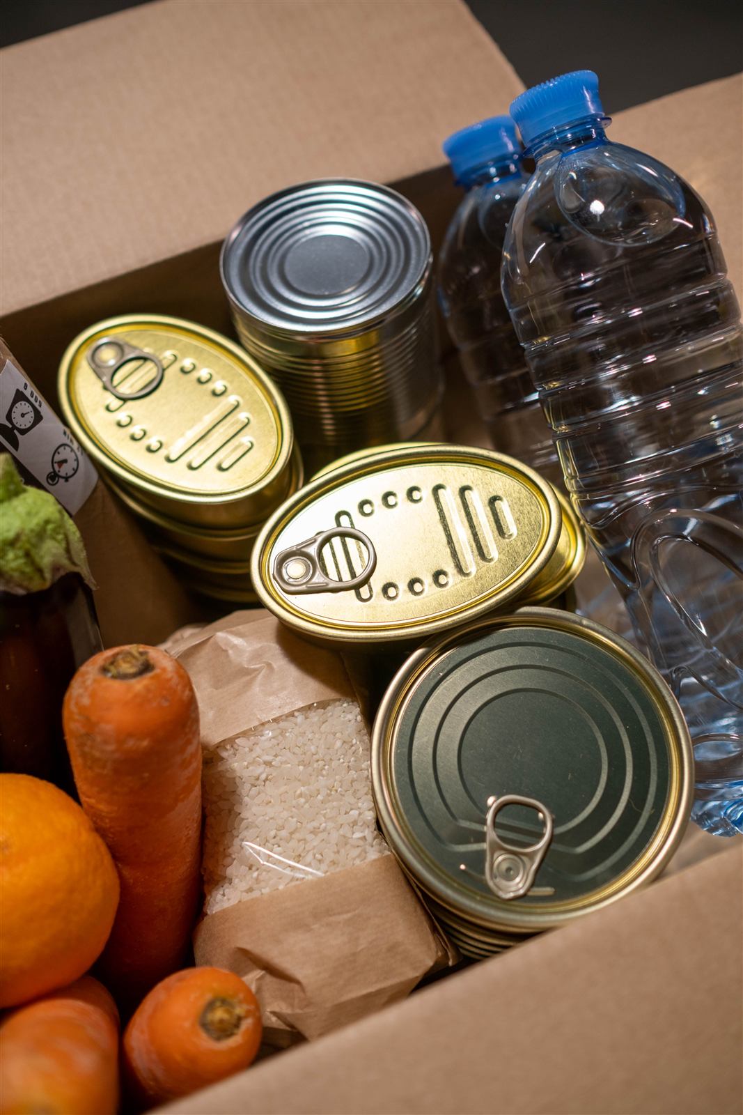 Volunteer holding a food parcel of fresh produce