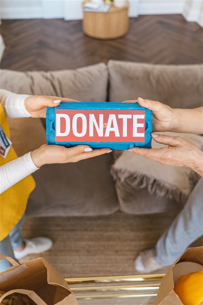 Two people handing over a donation together